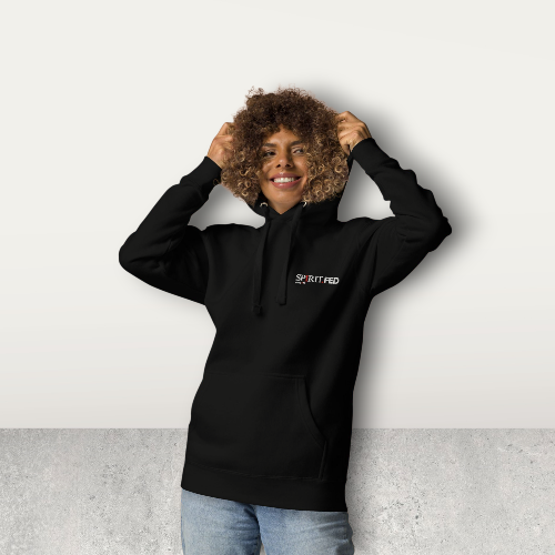 Person wearing a black hoodie with a logo, standing against a light gray background